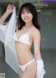 A woman in a white lingerie posing for a picture.