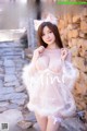 a woman in a white lingerie posing for the camera